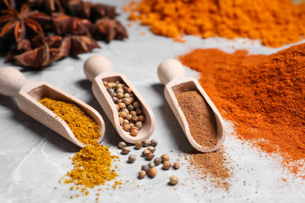 istock Scoops with different spices on gray marble table, closeup 1480126222