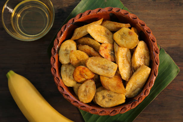 istock Flat lay composition with deep fried banana slices on wooden table 1480126368