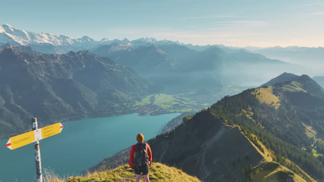 Aerial view of man hiking  on the background of Interlaken in Swiss Alps
