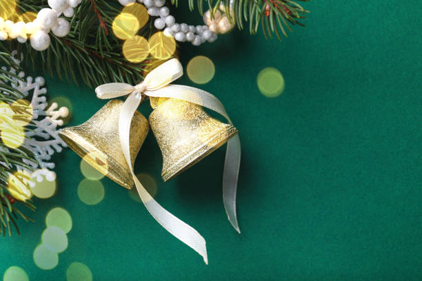 istock Christmas bells and fir tree branches with festive decor on green background, flat lay. Space for text 1480126996