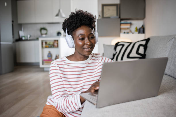 istock A young woman is sitting relaxed on the floor and using a laptop 1480132661
