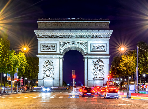 Triumphal arch (Arc de Triomphe) on Champs Elysees avenue at night, Paris, France