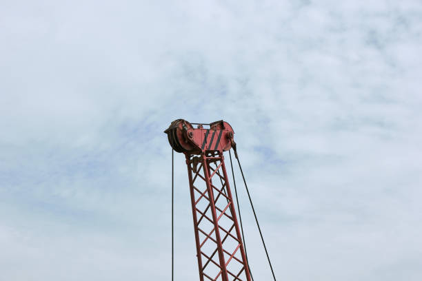 istock Part of a red crane with cables on a sky background. Construction crane. 1480134712