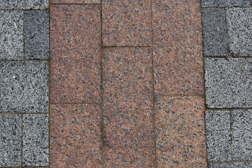 Brown-gray granite pavement. Pavement texture background
