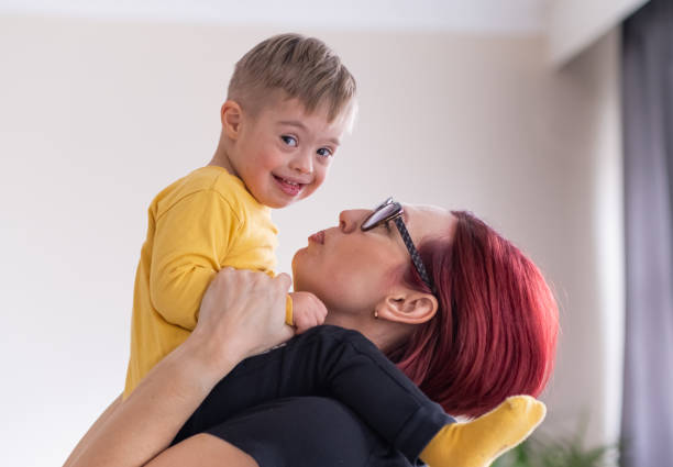 istock mother and child with Down syndrome exploring creativity with toy blocks, enjoying relaxing activity 1480137899