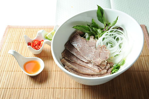 Beef Pork Brisket Soup Noodles with sauce served in bowl isolated on table top view of Soup powder