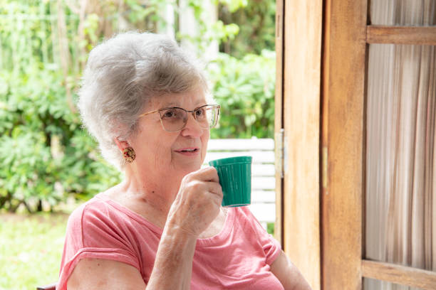 istock Elderly lady holding cup in the garden 1480150583