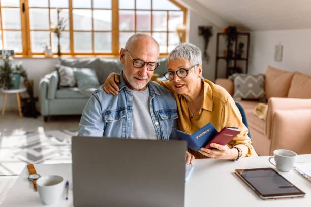 Senior couple planning vacation trip and searching information on internet