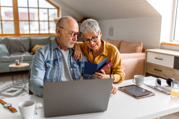 istock Senior couple planning vacation trip and searching information on internet 1480152267