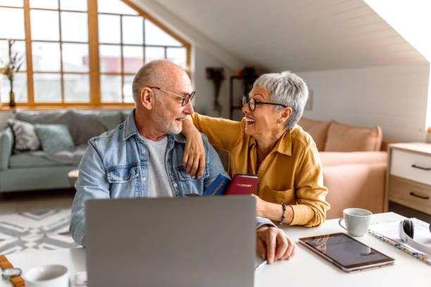 istock Senior couple planning vacation trip and searching information on internet 1480152342