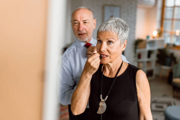 istock Senior woman applying a lipstick wile looking in a mirror 1480152927