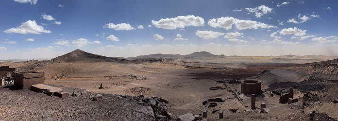 Merzouga, Morocco, Africa: panoramic view in the Sahara desert at the fossil mines in the Black Mountain area, blue sky and white clouds