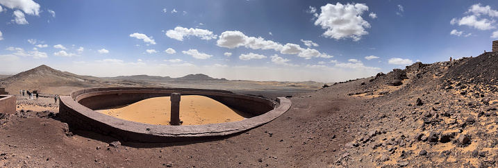 Merzouga, Morocco, Africa: panoramic view in the Sahara desert at the fossil mines in the Black Mountain area, blue sky and white clouds
