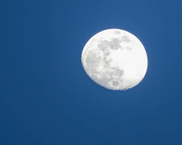 istock Waxing Gibbous Moon in Blue Sky 1480160184