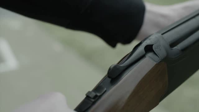 Hand reloading shotgun shells take aim stock video