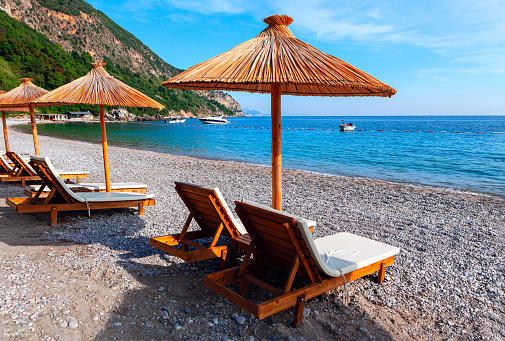 Beach chairs and parasols . Tropical paradise beach