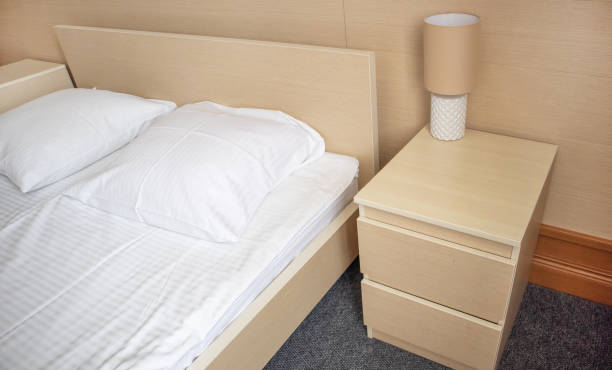 istock Bed and bedside table with lamp, modern bedroom interior 1480176451