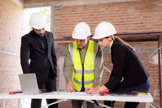 Team architect or engineer man and woman meeting for planning and strategy of development real estate at construction site, contractor and partner talking and looking blueprint, industrial concept. stock photo