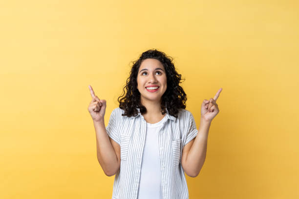 istock Woman pointing up at empty place for ad content and expressing positive emotions. 1480183903