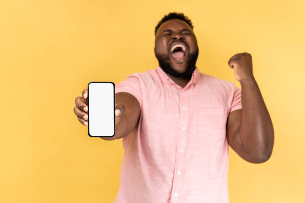 istock Man holding smartphone, screaming, making yes gesture, celebrating online lottery victory. 1480183907