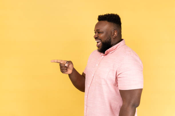 istock Man standing pointing away at copy space for advertisement or promotion. 1480183913