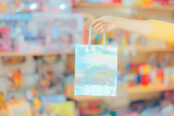 istock Customer Hand Holding a Holographic Shopping Bag in a Store 1480184503