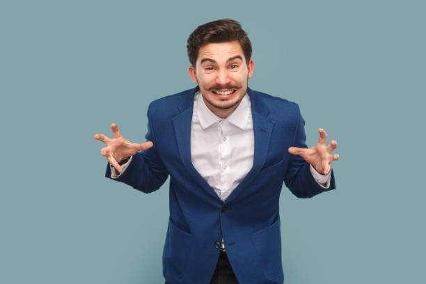 istock Angry aggressive attractive man standing clenched hid hands, screaming with anger and hate. 1480184643