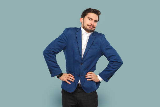istock Funny angry man with mustache standing with hands on hips, looking at camera with frowning face. 1480184647