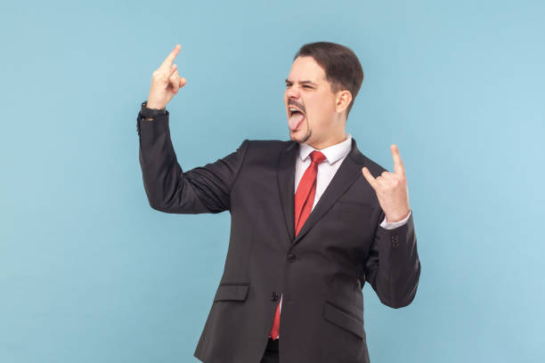 istock Crazy cool man with mustache standing showing rock and roll gesture, screaming with excitement. 1480184722