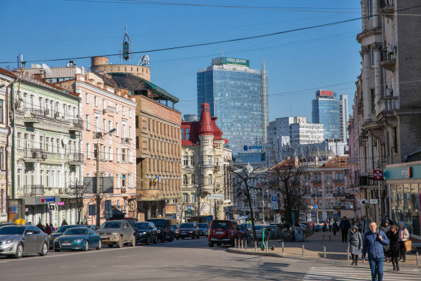 Lev Tolstoy street in Kyiv downtown, Ukraine. Kyiv, Ukraine - March 18, 2023: People walk along Lev Tolstoy street and square. It is a triangular intersection in Kyiv downtown. leo tolstoy stock pictures, royalty-free photos & images