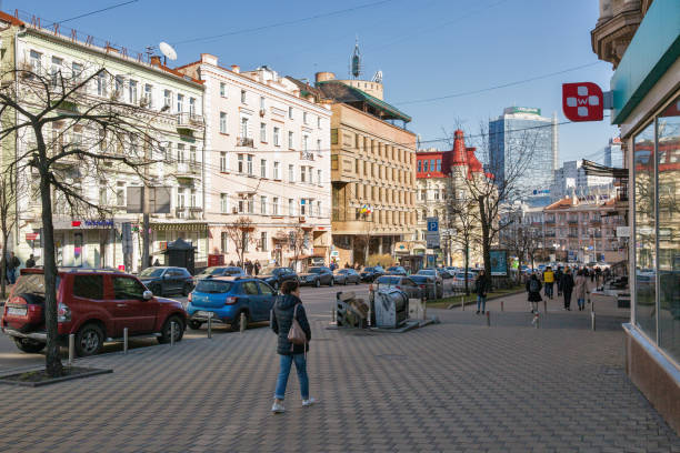 Lev Tolstoy street in Kyiv downtown, Ukraine. Kyiv, Ukraine - March 18, 2023: People walk along Lev Tolstoy street and square. It is a triangular intersection in Kyiv downtown. leo tolstoy stock pictures, royalty-free photos & images