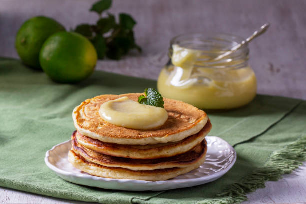 istock Whole grain flour fritters served with lime curd on a light background. Rustic style. 1480185129
