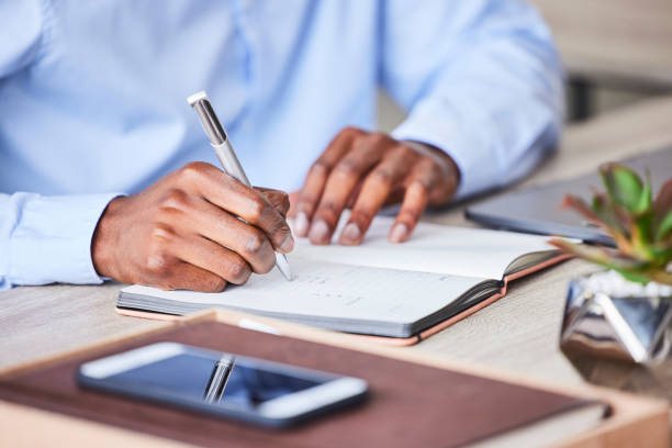 istock Business, man and writing in a notebook to plan a corporate strategy and ideas for development. Book, write and hand on paper to develop a professional idea while brainstorming at his desk 1480185184