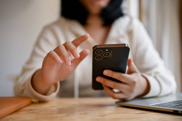 istock A young Asian woman using her smartphone while remote working in a co-working space. 1480192053