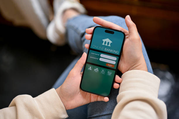 istock A woman using her mobile banking app on her phone while relaxing in a cafe. 1480192147