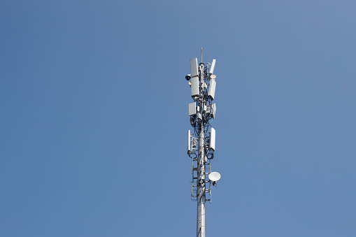 Three big radio mast with blue sky horizontal