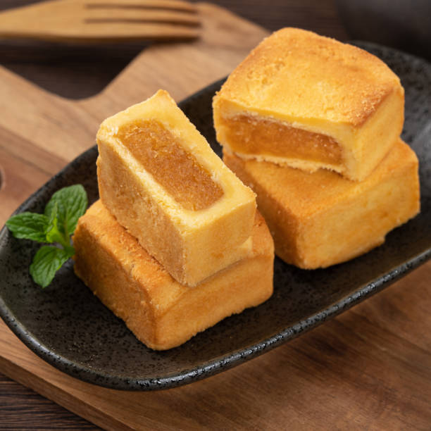 istock Delicious pineapple cake pastry in a plate on wooden table background with tea. 1480205789