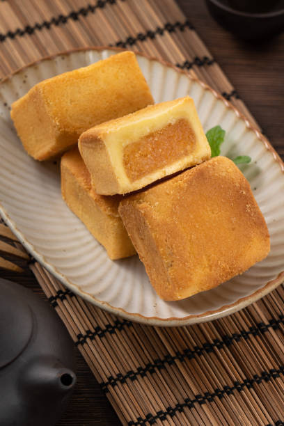 istock Delicious pineapple cake pastry in a plate on wooden table background with tea. 1480205793