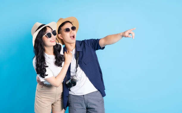 istock Asian couple traveling image  isolated on blue background 1480212945