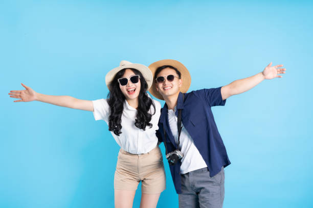 istock Asian couple traveling image  isolated on blue background 1480212961