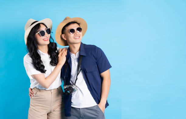 istock Asian couple traveling image  isolated on blue background 1480212966
