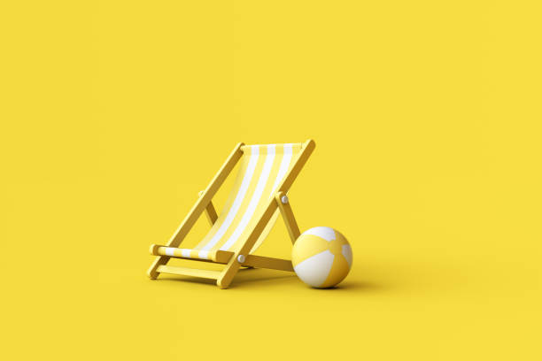 istock Striped deck chair and beach ball on yellow background. 1480214909