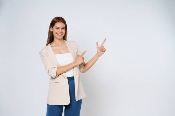 istock Young  woman pointing to empty copy space isolated on white background. 1480218222