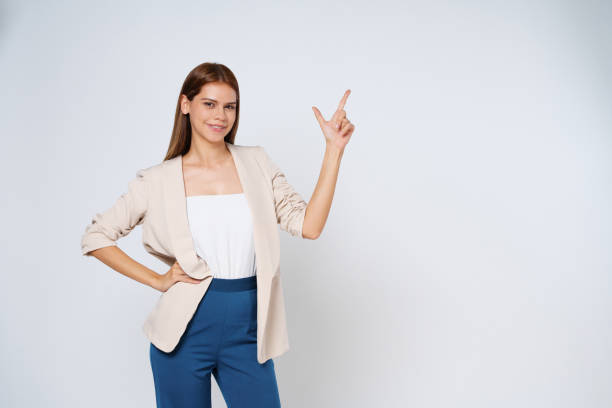 istock Young  woman pointing to empty copy space isolated on white background. 1480218226
