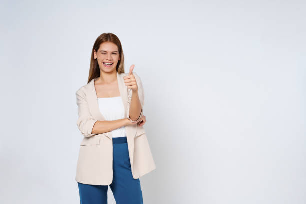 istock Young woman showing thumbs up isolated on white background. 1480218236