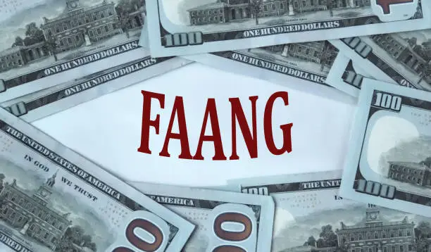 Photo of FAANG - acronym on the background of cash dollar bills