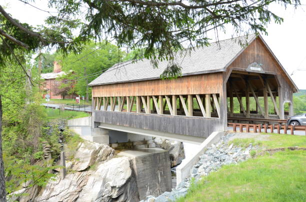 istock Quechee covered bridge in Canada with water below 1480221038