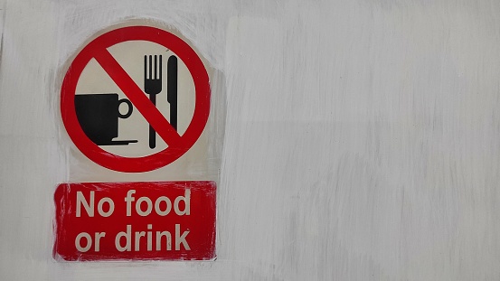 No food or drink sign on the white wall means food and drink is not allowed in this area