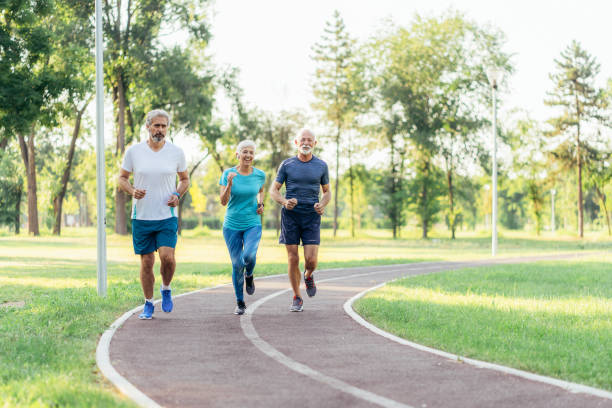 istock Three senior friends jogging together 1480223581