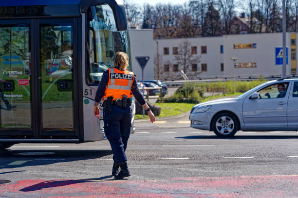 Policewoman regulating traffic at police block at scene of accident at Swiss railway station Emmenbrücke Gersag, Canton Lucerne. Photo taken March 22nd, 2023, Emmenbrücke Gersag, Switzerland.